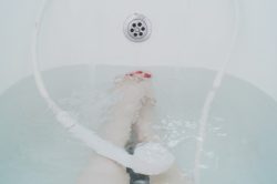 Womans feet under bath water
